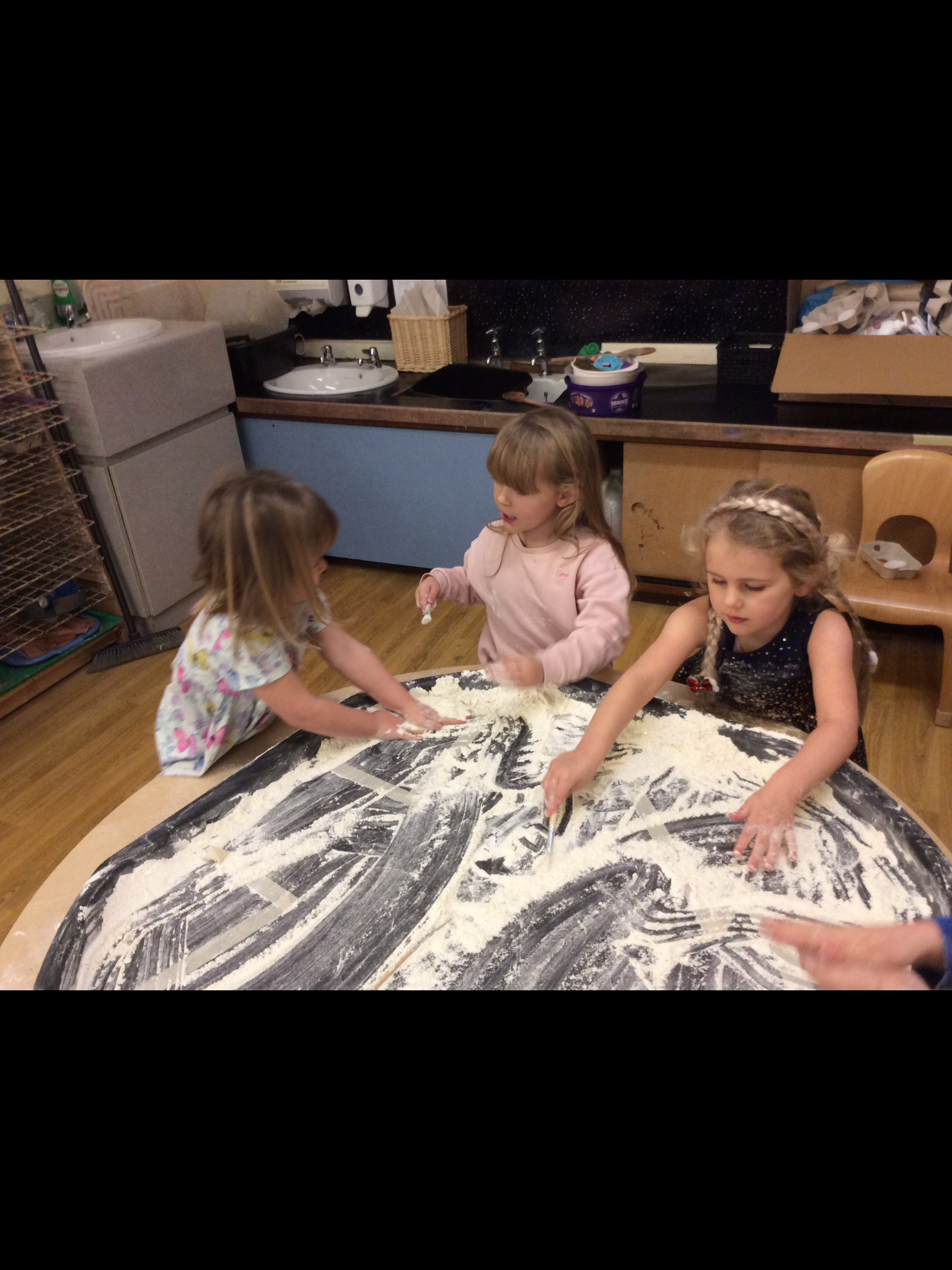 young children playing in sand