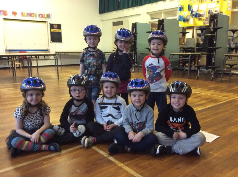 children wearing cycle helmets